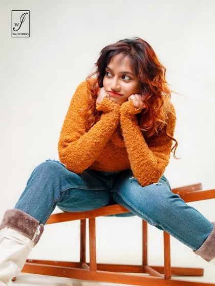 A thoughtful, daydreaming pose that adds a touch of softness and charm to the portfolio.