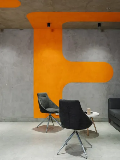 Another view of the lounge, showing how the organic orange shapes on the ceiling and walls define the seating area.