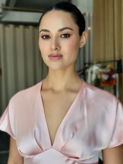 My philosophy is skin first, always. This portrait is completely raw and unedited, showcasing how the right skin work creates a luminous glow that looks incredible on camera without heavy editing. The look is minimal, with a soft pink wash on the eyes and lips, and a clean, sharp bun for a polished feel.