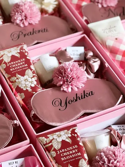 A close-up of the personalized bridesmaid hampers, showing the custom eye masks with names like "Yoshika" and "Prakriti".
