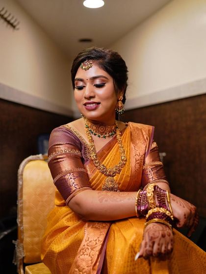 A seated portrait of the client. The makeup is flawless and enhances her features, making her feel confident and beautiful.