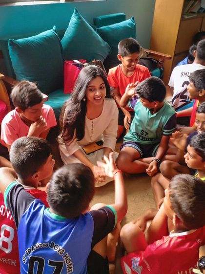 A circle of children and a volunteer engaged in conversation. These discussions are a vital part of our program, helping children express themselves and connect with others.