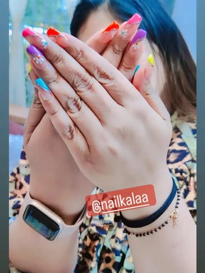 A fun and colorful set with each nail painted a different bright, summery shade. This look is perfect for holidays and festivals.