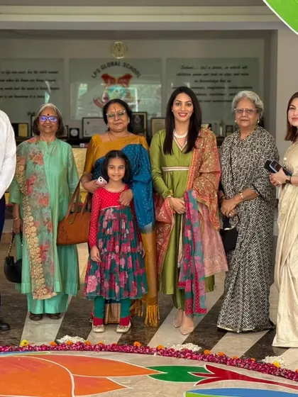 Guests and school leadership pose in front of a beautiful rangoli at our Annual Day. The entire campus is adorned with student artwork, reflecting the festive and creative spirit of the occasion.