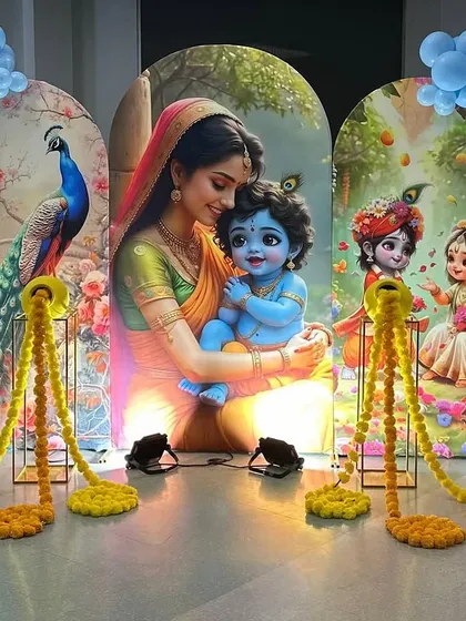 We also create beautiful setups for religious and cultural ceremonies. This Krishna-themed decoration for a baby's milestone event includes custom printed backdrops, balloon garlands, and traditional marigold flower accents.