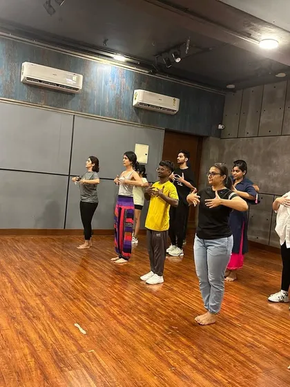 Here I am breaking down a move for my students. I provide personal attention to ensure everyone understands the technique and can perform the steps correctly and with confidence.