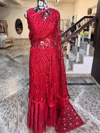 The complete 'LAALPARI' outfit, a fusion of a saree and a gown. This is for the woman who is not afraid to experiment with her style.