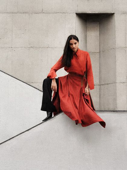 The flow of the red dress against the hard lines of the concrete staircase creates a beautiful contrast. This is a recurring theme in my architectural fashion shoots.