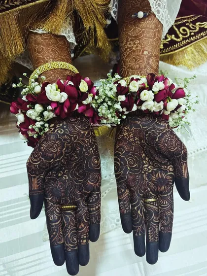 Your mehendi is the perfect accessory. Here you can see how the deep, rich stain of my natural henna beautifully complements the bride's floral jewelry and traditional attire.