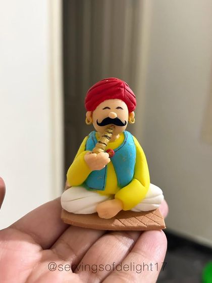 A close-up of one of the fondant figures from my competition entry. I spent hours sculpting this Rajasthani man, complete with a tiny turban and musical instrument.