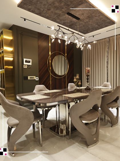 This dining area is designed for memorable gatherings. The sculptural chairs are works of art in themselves, gathered around a sleek table. I used a combination of a modern chandelier and warm wood paneling to create a sophisticated and inviting atmosphere.