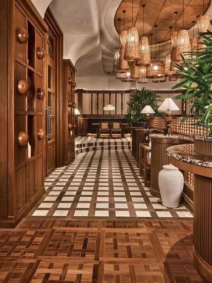 A long view of the space, where the repetition of wooden arches and the patterned floor create a strong sense of rhythm and direction.