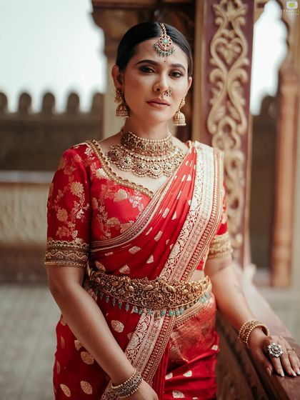 Another portrait of me in the red saree, this time with a focus on the beautiful architecture in the background.