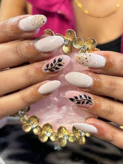 A beautiful off-white set with gold glitter accents and hand-painted black leaves for an artistic touch.