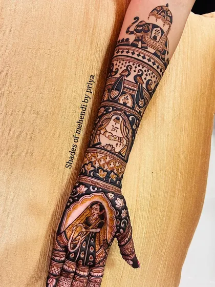 The complete arm design, showing how all the elements, from the bride in her doli to the royal elephant, come together to create a stunning bridal mehendi.