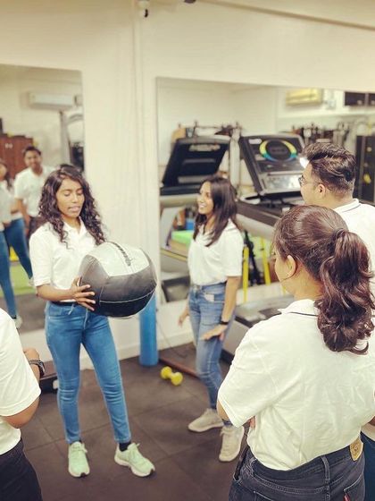 Our team is always revisiting the basics to build a strong foundation for advanced treatments. Here, a team member demonstrates an exercise with a medicine ball during a training session.