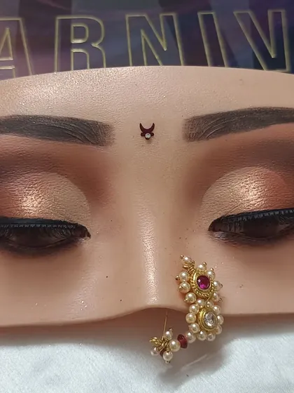 An earthy brown smokey eye with a touch of shimmer. This is a versatile look that suits many skin tones and is perfect for an engagement or reception party.