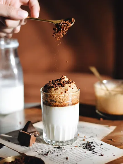 Remember Dalgona coffee? This shot captures the trend with its distinct layers of whipped coffee and milk, with a sprinkle of coffee grounds for texture and action.