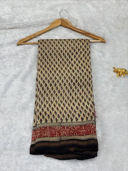 This Bagru printed saree on Maheshwari silk features a classic combination of beige, red, and black. The traditional border and bootis give it an authentic, artisanal feel.