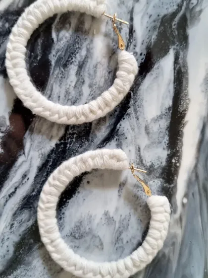 For a classic, neutral look, I offer these macrame hoop earrings in a beautiful off-white. They pair perfectly with any outfit, adding texture and a touch of bohemian elegance.