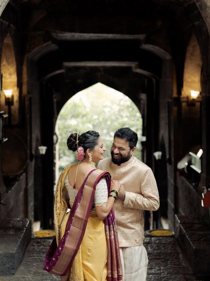 Another perspective of the couple in the temple archway, this time with a focus on their joyful interaction. Their smiles are infectious, capturing the happiness of the moment.