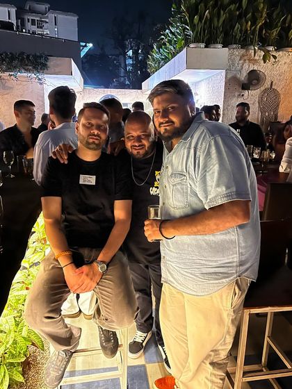 Posing with friends at a birthday celebration. It's not just about the music, but also about being part of the celebration with the people there.