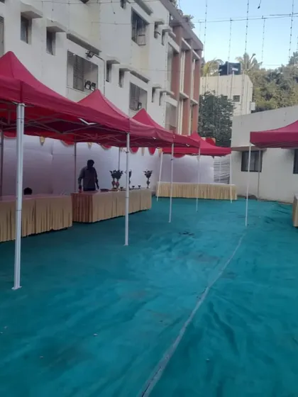 For outdoor trade shows or corporate fun days, we provide functional and professional setups like these red gazebos. Each stall is equipped with covered tables, creating a uniform and organized look for vendors or information booths.