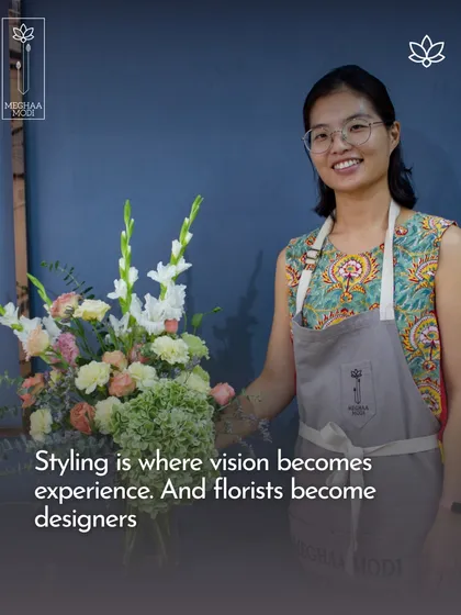 Styling is where vision becomes experience, and florists become designers. This student is proudly displaying her work, which shows a strong sense of composition and style.