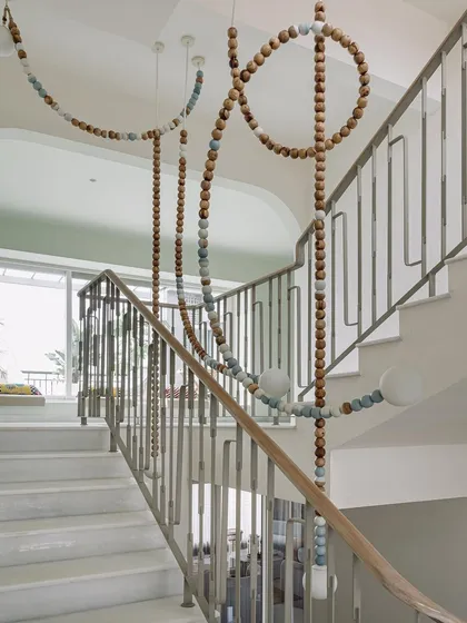 This is the 'Luna' light installation at Eden House, a piece we designed to be the soul of the stairwell. Crafted from wooden beads to depict the phases of the moon, it transforms a simple transitional space into a captivating artistic experience, blending form, function, and a touch of magic.
