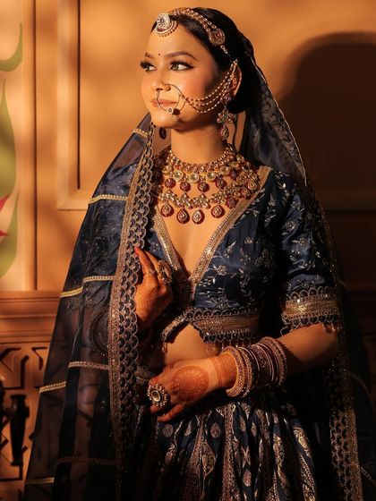 Three shots of a model in a royal blue Banarasi lehenga. These images showcase the outfit's rich texture and how it can be styled for a majestic, traditional photoshoot.