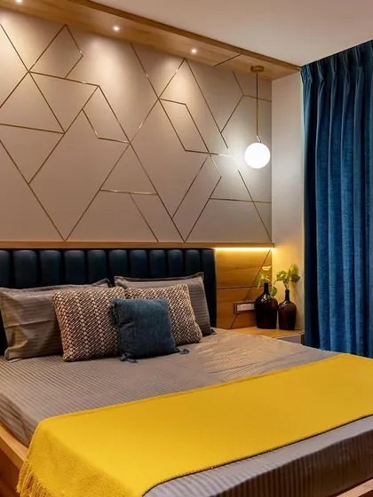 Another angle of the geometric-themed bedroom, showcasing the deep blue curtains that complement the headboard and contrast beautifully with the yellow accents.