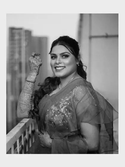 A timeless black and white portrait of Priya on the balcony. Monochrome photos often highlight emotion and expression beautifully.
