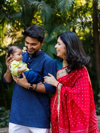 A candid moment of smiles and admiration between new parents and their baby. These natural interactions make for the most heartwarming family photos.