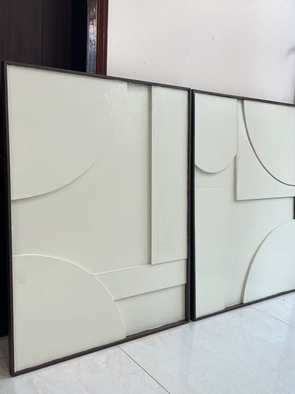 A diptych of minimalist sculptural art for a residence in Mumbai. These 30" x 24" panels use clean, curved, and straight raised forms on a simple off-white background for a subtle yet sophisticated look.