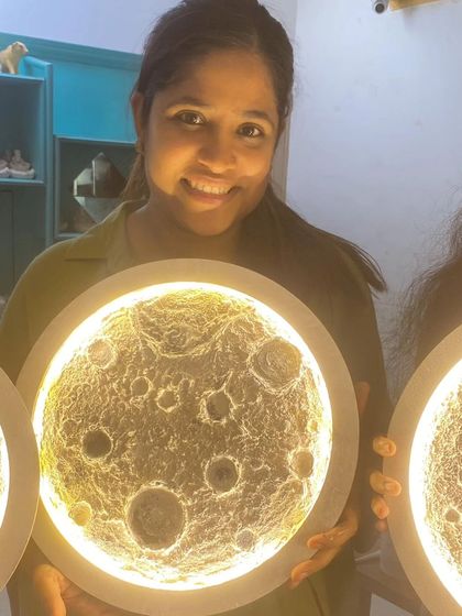 Another happy creator from our 3-D Moon workshop. The warm glow of the lamp highlights the intricate crater details she carefully crafted.