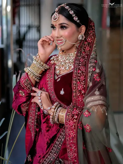 A candid moment captured as the bride adjusts her dupatta, showing the flow and detail of her outfit.