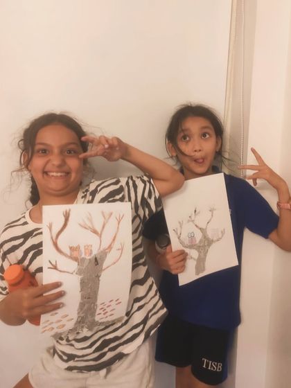 Striking a pose with their finished tree artwork. Our classes are as much about having fun as they are about learning.