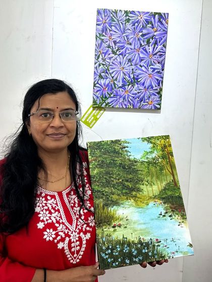 Holding my landscape painting at the Rangoli Metro art gallery.