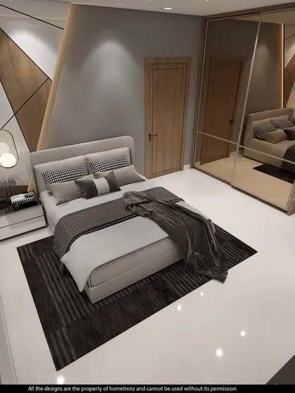 The geometric accent wall is the star of this bedroom, creating a dynamic focal point behind the bed.