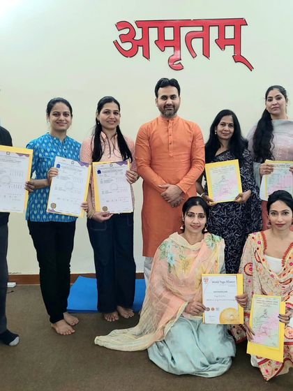 A group photo with our graduates, each holding their hard-earned 'Yogacharya' qualification. This marks the beginning of a new chapter in their yoga journey.
