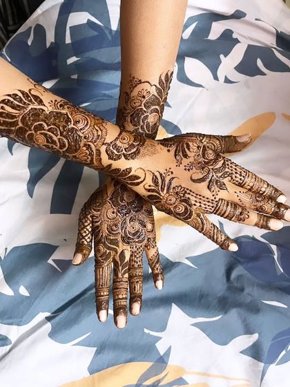 A different angle of the rose-themed henna, showing how the design flows from the wrist to the fingers.