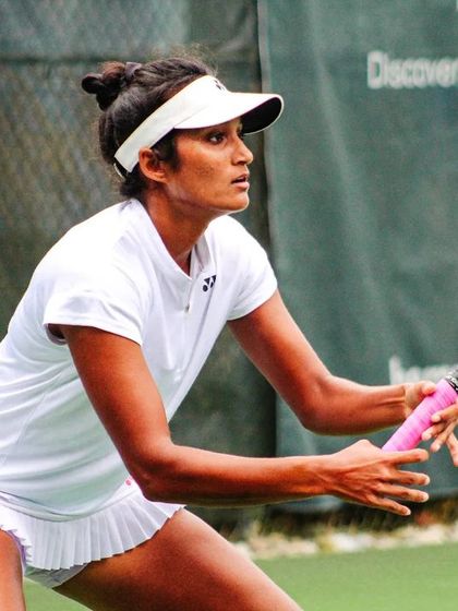 Sahaja's focused expression and ready position highlight her mental preparation and readiness for competition.