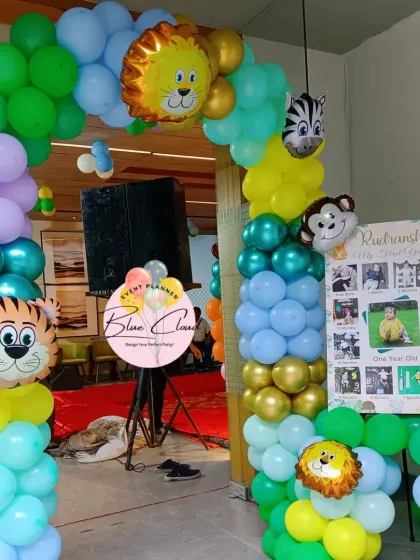 A jungle animal themed entrance arch made of colorful balloons and animal head foil balloons, perfect for welcoming guests to a birthday party.