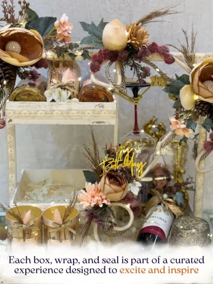 Each box, wrap, and seal is part of a curated experience. This multi-tiered hamper, adorned with dried florals and fairy lights, is designed to excite and inspire.