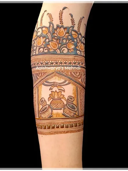 A detailed design on the arm featuring a kalash, a symbol of prosperity and good fortune, perfect for a wedding.
