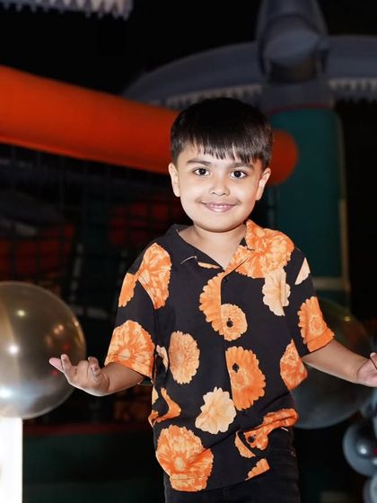 A happy portrait of the birthday boy, Ansh. His bright smile shows just how much fun he's having at his amazing Halloween-themed 5th birthday party.
