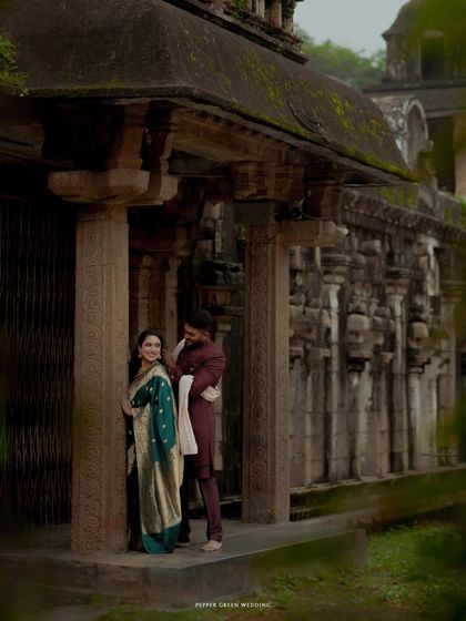 A pre-wedding portrait set against the majestic stone architecture of a Thanjavur temple, blending their love story with the grandeur of South Indian heritage.