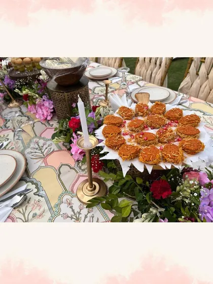 Another view of the beautiful outdoor dining setup, with platters of appetizers already placed on the table for guests to enjoy.