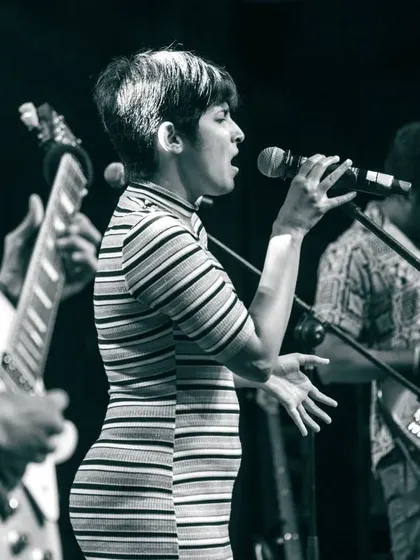 A powerful moment captured during a full-band show. For me, music is about this raw, collaborative energy. This black and white shot shows me completely lost in the song, which is the kind of passion I bring to every performance.