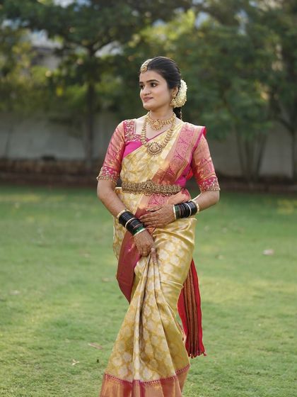 The classic bridal pose. Her makeup is subtle yet defining, with a focus on flawless skin and expressive eyes, ensuring she looks timeless in her wedding portraits.
